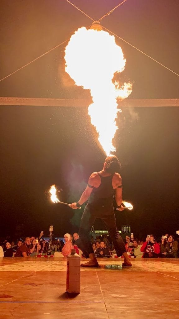 Traditional fire juggling show at a desert safari evening