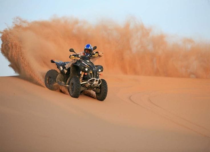 Quad bike ATV parked on Abu Dhabi sand dunes for desert safari