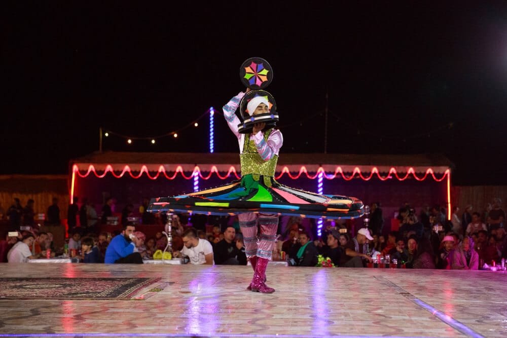 Tanoura dance show desert camp Abu Dhabi senior guests watching
