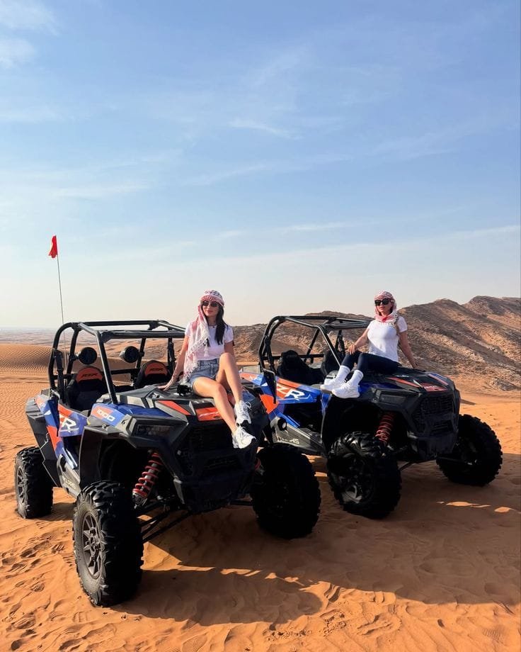 Guests posing with the buggy before a desert run