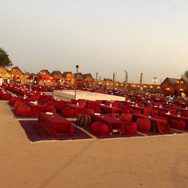 Royal Arabian Safari desert camp glowing in the Al Khatim dunes at dusk