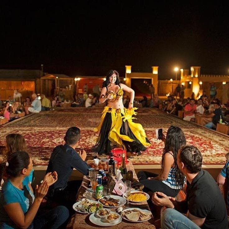 Professional belly dancer in colourful costume at a desert safari camp