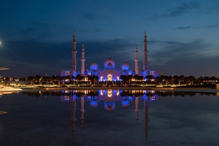 Grand Mosque in Violet Light Sheikh Zayed Grand Mosque at night with violet lighting mirrored in the water