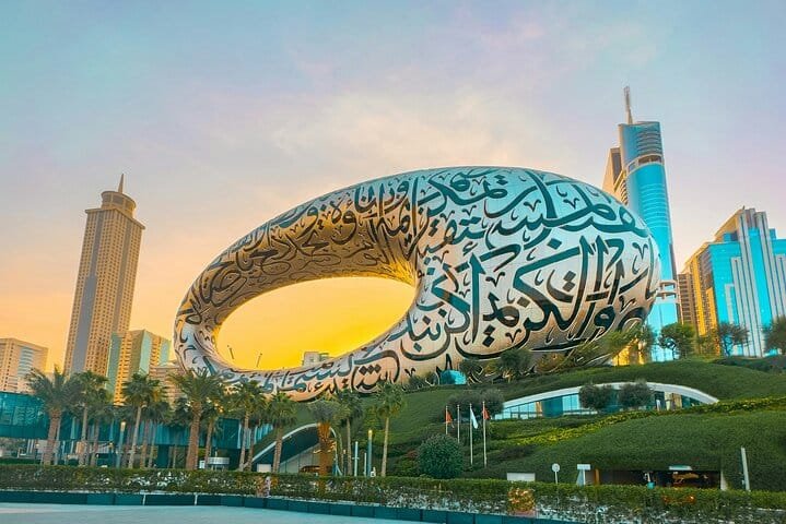 The Museum of the Future in Dubai at golden hour, its steel torus covered in Arabic calligraphy