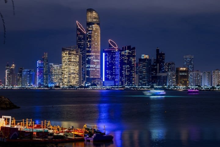 Abu Dhabi Corniche Skyline at Night The Abu Dhabi Corniche skyline lit at night, seen across the water from the dhow harbour