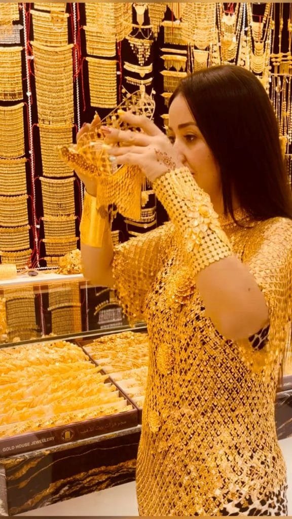 Woman adorned with elaborate traditional gold jewellery in Dubai