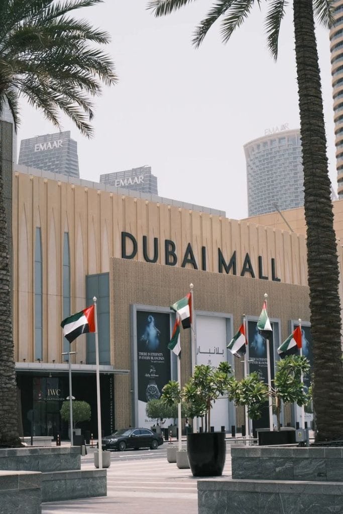 Exterior facade of The Dubai Mall with UAE flags