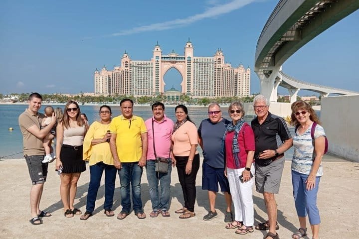 Our guests photographed together at The Pointe with Atlantis The Palm behind, on a private Dubai city tour