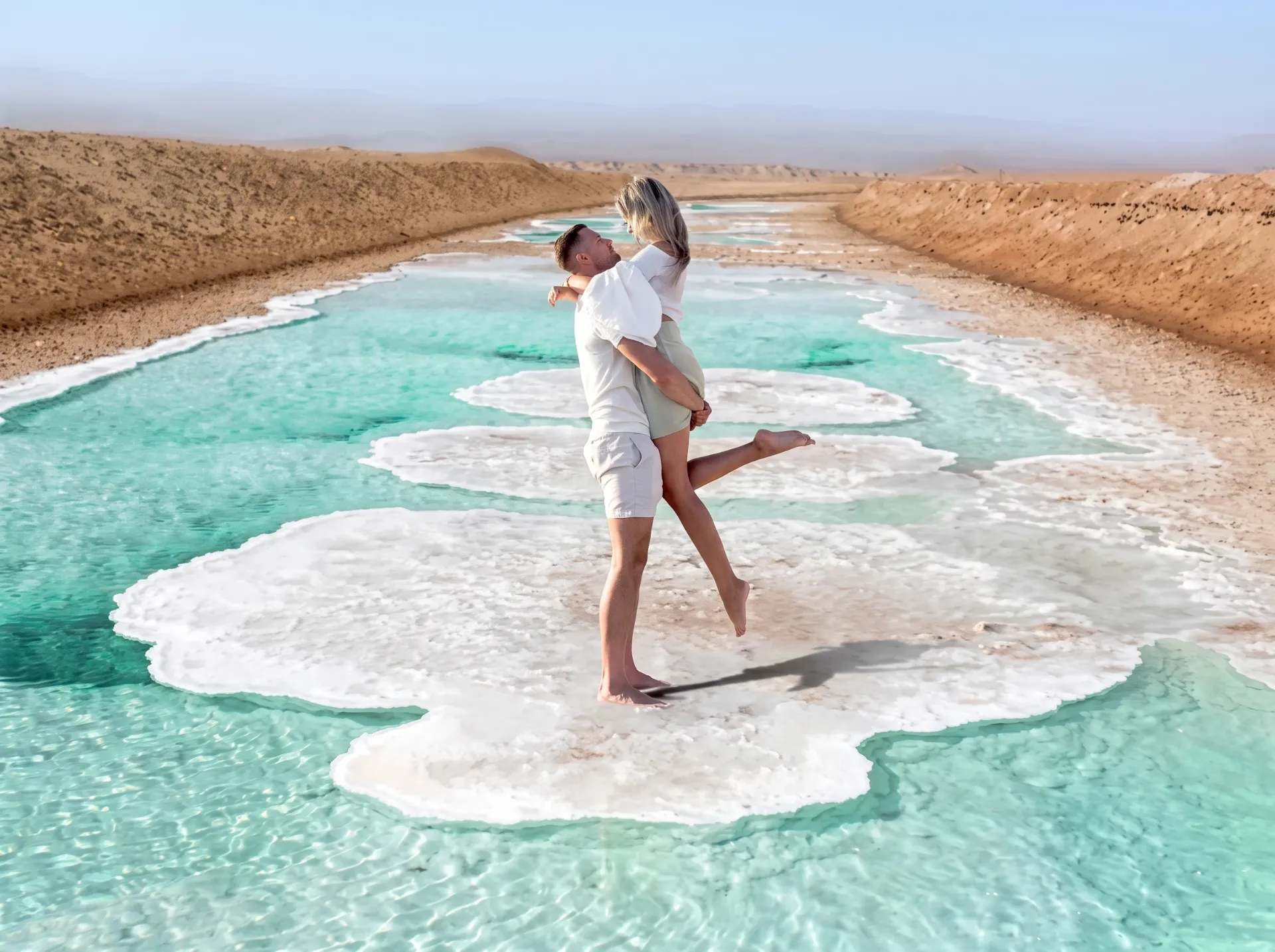 Turquoise water and white salt crust formations at Al Wathba Long Salt Lake in the Abu Dhabi desert