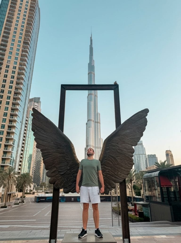 Burj Khalifa framed by the angel wings sculpture on a clear day