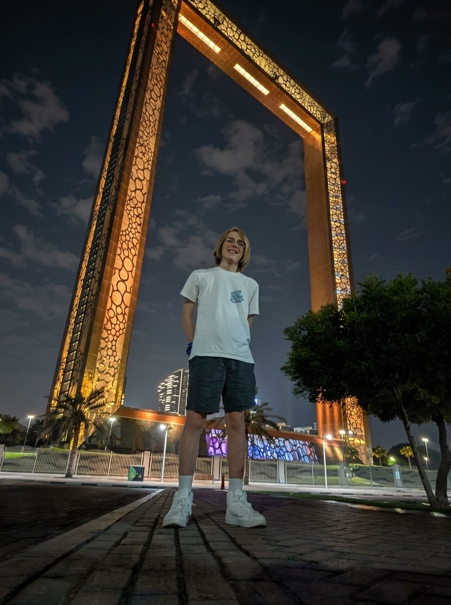Traveller standing beneath the golden lattice of the Dubai Frame