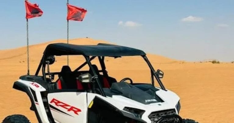 Can-Am dune buggy with roll cage on the golden dunes of Al Khatim, Abu Dhabi