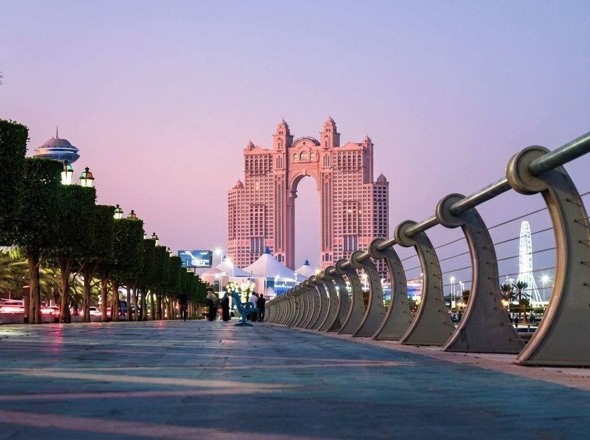 Abu Dhabi marina promenade lit at dusk on an overnight layover city tour