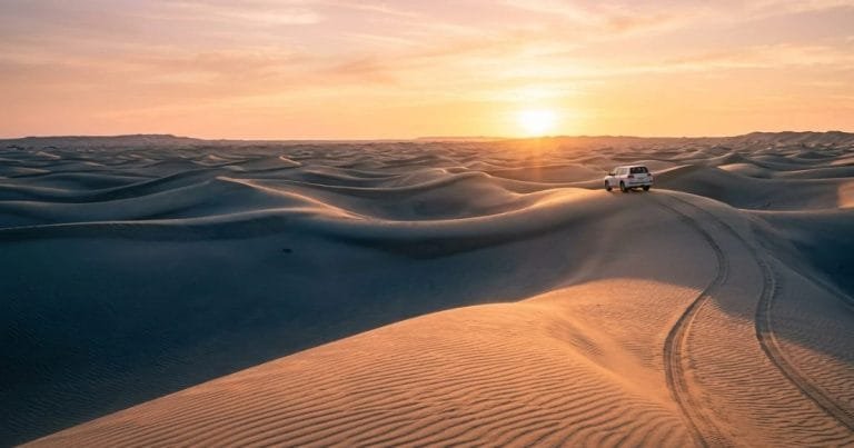 Desert sand dunes glowing at sunrise